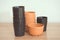 Stacked empty plant pots on wooden background