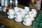 Stacked empty teacups with teaspoons at a function over