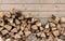 Stacked firewood as background, closeup. Heating house in winter