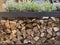 Stacked firewood for kindling the stove or fireplace. Wooden background