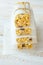 Stacked Homemade Granola Muesli Cereal Bars with Oats Nuts Raisins Honey Dried Apples. Lined with Parchment Paper Tied with Twine.