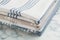 Stacked kitchen towels on white marble table, closeup