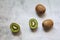 Stacked kiwi, cut kiwi and whole kiwi fruit, fruit with peel and with small seeds, fresh vitamins, natural products