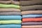 Stacked multicolored clothing fabric in the closet bed linen banner.