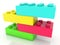 Stacked on by one four toy bricks in different colors.3d illustration
