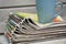 Stacked and piled up newspapers on a wooden table background