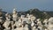 Stacked rock towers on mountain top for spiritual purposes - camera pan