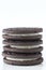 Stacked sandwich cookies on white background with negative space for copy