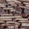 Stacked sawn boards from the warehouse. Seamless texture of folded wooden boards.