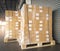 Stacked of shipments boxes on pallet with hand pallet truck waiting for load into a truck. Road freight cargo industry.