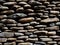 Stacked Smooth Riverstones Wall Background