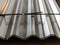 Stacked stainless galvanized profiled sheet. Silver colored construction material