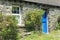 Stacked stone cottage with blue door in Ireland