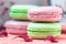 Stacked, tasty pink and green Macaroons, colorful delicious French pastries, strawberry and pistachio macaroons
