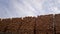 Stacked Timber Planks at a Lumberyard Awaiting Transportation. Stacked wooden planks in varying shades of brown at a