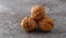 Stacked walnuts on a gray background