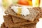 Stacked wholemeal crispbread with cream cheese and honey