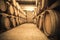 Stacked wine barrels in the old cellar of the winery