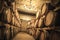 Stacked wine barrels in the old cellar of the winery