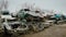 Stacked wrecked cars on grungy junkyard