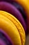 Stacked yellow and purple macarons vertical background