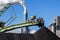 Stacker-reclaimer in a coal handling terminal with in the background a coal power plant