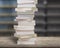 Stacking books on wood desk with blur bookshelfs background