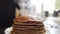 Stacking freshly cooked pancakes into pile