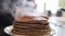 Stacking freshly cooked pancakes into pile