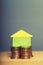 A stacking gold coins and home. Business and Finance Concept