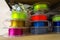 Stacks of 3d printing filament in different colors lying on shelf