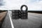 Stacks of car tires on asphalt highway