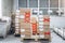 Stacks of cardboard boxes with products in the factory`s packaging workshop. Some of them are marked with red tape