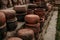 Stacks of ceramic red clay brick pots for plants in a greenhouse or for cooking
