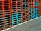 Stacks of colorful pallets in the warehouse yard