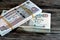 Stacks of Egypt money banknote bills of 100 and 50 EGP LE one hundred Egyptian and fifty Pounds isolated on wood features Sultan