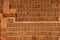 Stacks of fired clay bricks with identical holes abstract horizontal background