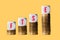 Stacks of gold coins with cubes spelling FTSE to show rise in value of the index in London