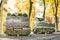 Stacks of green fresh rolled lawn grass on wooden pallet at dirt prepared for installation at city park or backyard in autumn.