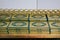 Stacks of green and golden Quran or Quraan books at shelf, closeup detail