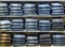 Stacks of jeans trousers in display in a shop in rows on wooden shelves