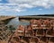 Stacks of lobster traps on a pier in Scotland