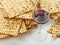Stacks of matzah-Jewish Passover bread and red wine in a glass. White background. Low angle view. Jewish Passover, religion,