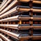 Stacks of metal pipes, construction components for industry, in storage in warehouse