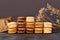 Stacks of natural brown, beige and cream colored French macarons with coffee, mocha, chocolate and vanilla flavour