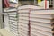 Stacks of new textbooks on a shelf in the school library.