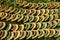 Stacks of old orange weathered roof shingles.