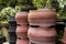 Stacks of painted Terracotta clay pots for sale at a garden supplies store