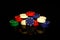 Stacks of poker chips with a blue chip in front isolated on black with reflections