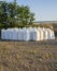 Stacks of raffia fertilizer sacks stacked over ground